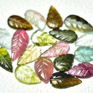 May include: A collection of 17 carved gemstone leaf shapes in various colors, including green, pink, brown, and blue.