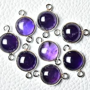 May include: Eight silver-toned pendant charms with amethyst gemstones. Each charm has two loops for attaching to jewellery.
