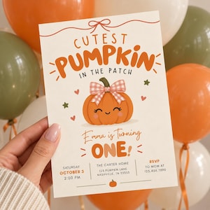 May include: A rectangular birthday invitation card featuring the text Cutest Pumpkin in the Patch and Emma is Turning One. The design includes a central orange pumpkin illustration with a pink gingham bow, small hearts, stars, and event details.