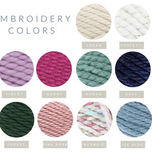 May include: A chart of embroidery floss colors with the title "Embroidery Colors". The colors are: Cream, Confetti, Violet, Berry, Ocean, Navy, Forest, Pink Rose, Mermaid, and Ice Blue.
