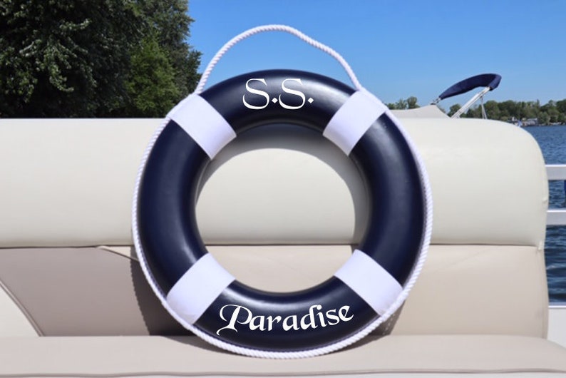 May include: A blue and white life preserver with the text "S.S. Paradise" printed on it.