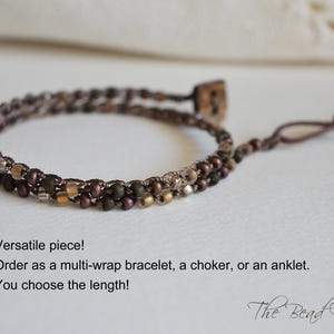 May include: A multi-wrap bracelet with brown and gold beads. The bracelet can be worn as a bracelet, choker, or anklet. The length is customizable. The Bead Farm logo is in the bottom right corner.