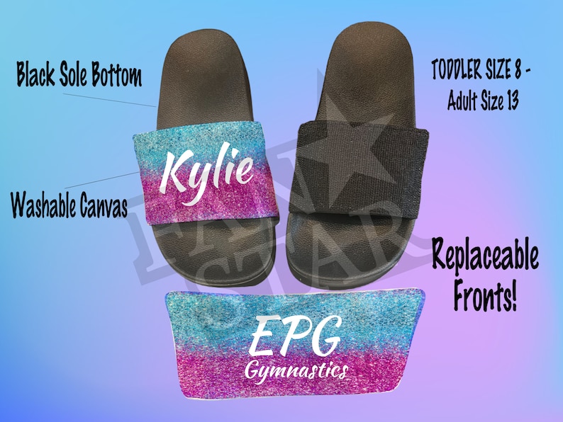 May include: A pair of black canvas slides with a replaceable front. The front is a glittery ombre design in blue and pink with the text "Kylie" in white. The front is also available in a blue and pink ombre design with the text "EPG Gymnastics". The slides are available in sizes toddler 8 to adult 13.