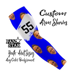 May include: Blue custom arm sleeve with a white section featuring the number 55 in black. The sleeve has a pattern of smiling faces and the text "Custom Arm Sleeves". The logo "FAN STAR" is also visible.