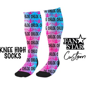 May include: A pair of knee-high socks with a watercolor design in shades of pink and blue. The socks feature a repeated pattern of a silhouette of a person doing a cheerleading pose with the name "Chloe" written in black. The socks are black at the toe and heel. The text "KNEE HIGH SOCKS" is written in black at the bottom left of the image. The text "FAN STAR Custom" is written in black at the bottom right of the image.