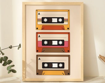 May include: A framed print with a retro design featuring three vintage cassette tapes with the letter "A" on each. The tapes are in shades of yellow, orange, red, brown, and pink.