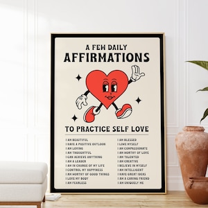 May include: A framed poster with a retro design featuring a red heart character with arms and legs. The poster reads "A Few Daily Affirmations To Practice Self Love" with a list of positive affirmations below. The poster is in a black frame.