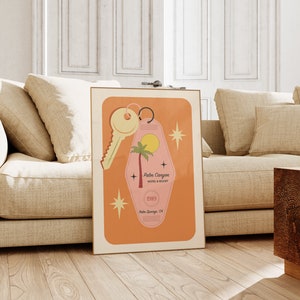 May include: A retro-style motel key tag with a pink background and a palm tree silhouette. The tag reads "Palm Canyon Motel & Resort" and "1989 Palm Springs, CA". A gold key is attached to the tag.