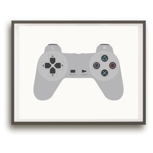 May include: A framed print of a gray video game controller with black buttons and a white background. The controller has the words "Select" and "Start" printed on it.