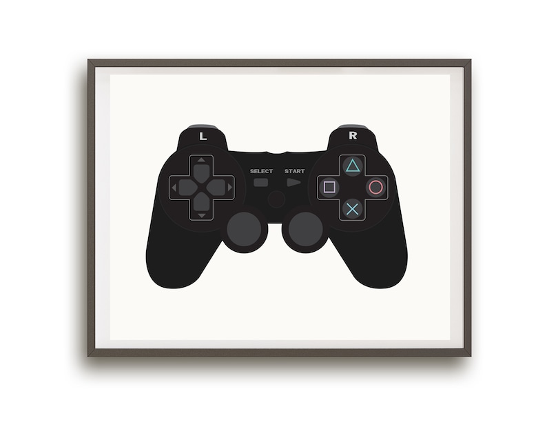 May include: A black video game controller with buttons labeled 'Select', 'Start', 'L', and 'R'. The controller is framed in a gray frame.