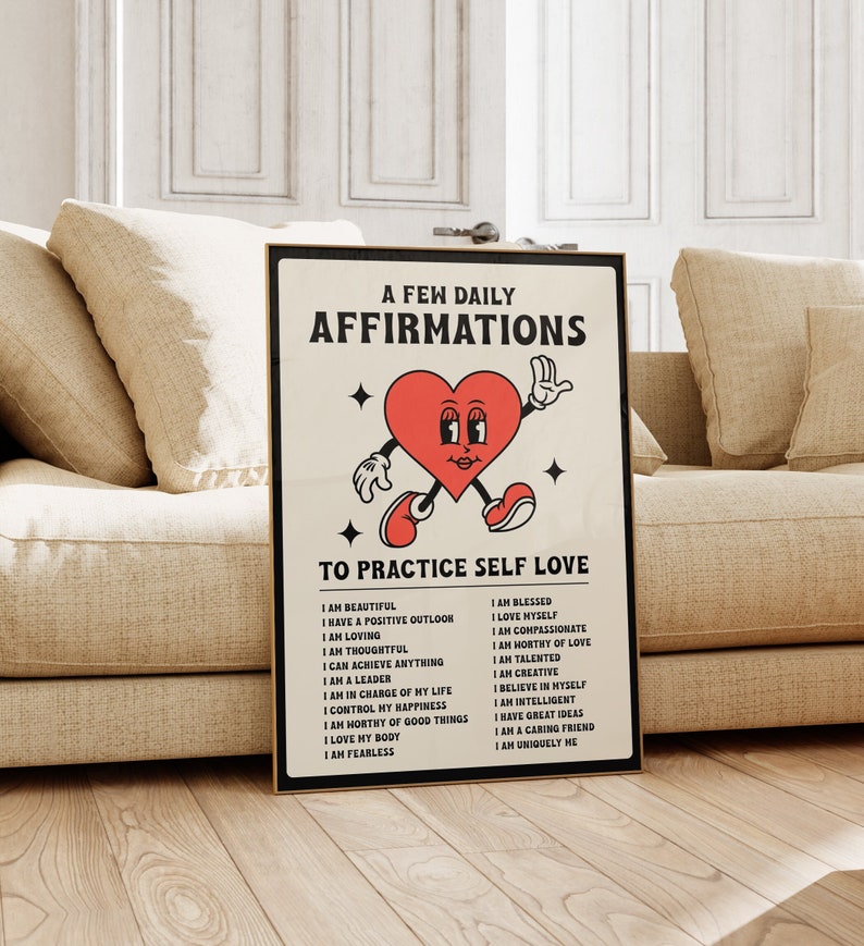 May include: A framed poster with the text "A Few Daily Affirmations To Practice Self Love." The poster features a cartoon heart character with arms and legs. The affirmations are listed below the character.