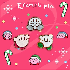May include: Enamel pins featuring a pixelated design of a character in various poses, with a candy cane and snowflakes on a pink background. The pins have glittery white bodies and gold accents. Text at the top reads "Enamel pin."