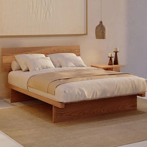May include: A low-profile wooden bed frame with a horizontal slat headboard, featuring a white mattress, a beige runner, and two white pillows. The bed is flanked by two wooden side tables, each holding a candle, with two hanging pendant lights.