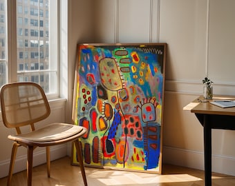 May include: An abstract artwork in a wooden frame leans against a wall. The painting displays a vibrant mix of colours, including blue, yellow, red, and green. A wooden chair with a woven seat and a small table with a plant are also visible.
