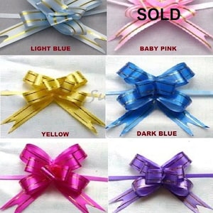 May include: Assortment of six gift bows in various colours, including light blue, baby pink, yellow, dark blue, pink, and dark purple. Each bow has a gold stripe pattern.