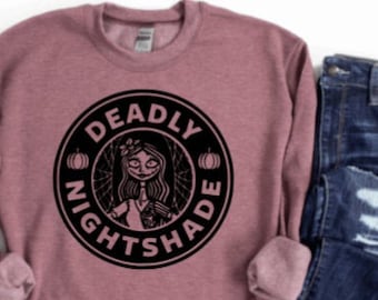 May include: A mauve sweatshirt with a black circle graphic featuring a cartoon character with the text "DEADLY NIGHTSHADE".
