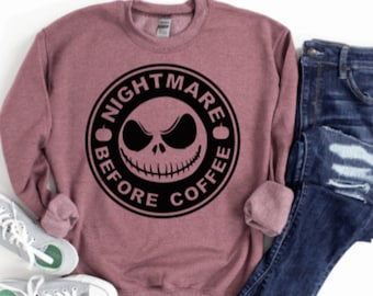 May include: A maroon sweatshirt with a black and white graphic of Jack Skellington's face in a circle with the text "Nightmare Before Coffee".
