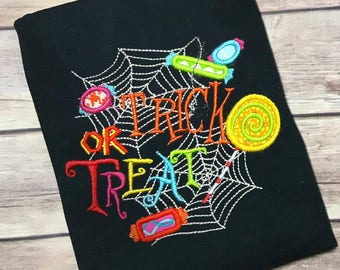 May include: Black t-shirt with an embroidered design of a spider web, candy, and the text "Trick or Treat".