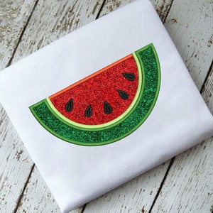 May include: A red and green watermelon slice with black seeds, embroidered on a white fabric.