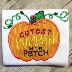 May include: Orange pumpkin with a green stem and leaves, embroidered with the text "Cutest Pumpkin in the Patch".