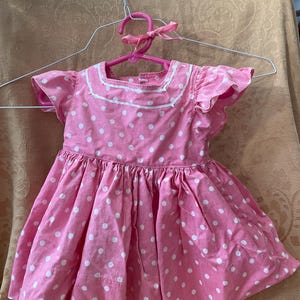Pink Polka Dot Patti Playpal Dress with Matching Pink Bow for Hair - four buttons down the back