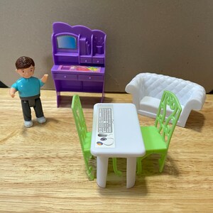 Five (5) pieces of dollhouse furniture with one dollhouse person