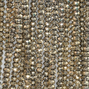 May include: Close-up of multiple strands of faceted, golden-colored beads. The beads are oval-shaped with multiple facets, creating a sparkling effect. The beads are strung together, forming vertical lines. Ideal for jewelry making.