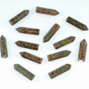 May include: A collection of 12 green, brown, and red gemstone points with a hole drilled through the top. The points are all roughly the same size and shape, and they have a speckled appearance.