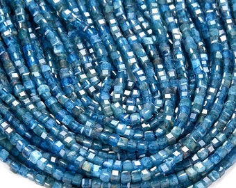 May include: A strand of blue apatite beads, each bead is faceted and has a square shape.