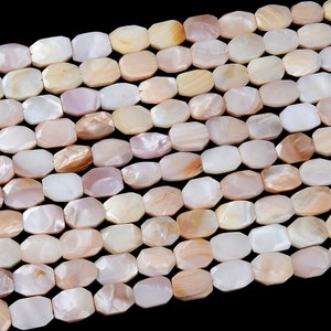 May include: A strand of white and pink iridescent shell beads with a faceted, rectangular shape.