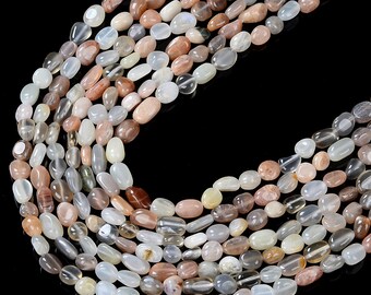 May include: A strand of sunstone beads in various shades of white, gray, and brown. The beads are oval shaped and have a smooth, polished finish.