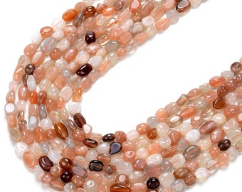 May include: A strand of sunstone beads in various shades of orange, pink, and white. The beads are oval shaped and have a smooth, polished finish.