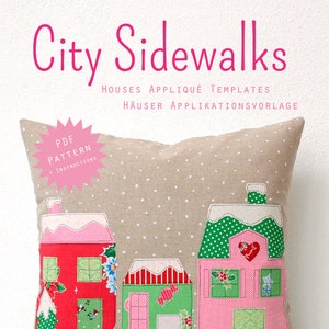 May include: A beige pillow with a snowy scene of three houses appliqued on it. The houses are red, pink, and green with white trim and snow-covered roofs. The pillow has a white background with small white dots. The text "City Sidewalks" is at the top of the image in pink letters. The text "PDF Pattern + Instructions" is in a pink starburst shape. The text "Houses Appliqu&eacute; Templates" and "H&auml;user Applikationsvorlage" is below the pillow in pink letters. The text "Designed by Nadra Ridgeway" and "www.ellisandhiggs.com" is at the bottom of the image in black letters.