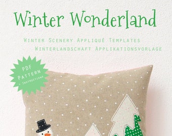 May include: A decorative pillow with a winter theme. The pillow features a snowman, Christmas trees, and the text "Winter Wonderland." The design includes a beige background with white polka dots, green, pink, and white accents. The bottom of the pillow is pink.