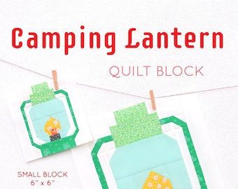 Könnte beinhalten: Ein Quiltblock-Muster für eine Campinglaterne. Das Muster umfasst zwei Größen: einen kleinen Block von 15 cm x 15 cm und einen großen Block von 30 cm x 30 cm. Das Muster wurde von Nadra Ridgeway von ellisandhiggs.com entworfen.