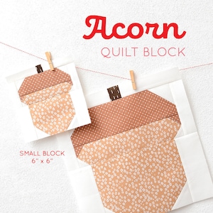Könnte beinhalten: Zwei Quiltblöcke, klein und groß, zeigen ein Eicheldesign. Der kleine Block ist 15 cm x 15 cm groß, und der große Block ist 30 cm x 30 cm groß. Die Eichelspitzen sind braun mit weißen Punkten, und die Körper sind pfirsichfarben mit weißen Blumenmustern. Der Text "Acorn QUILT BLOCK" steht oben.