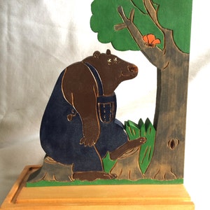 wooden bookend with a bear watching a butterfly
