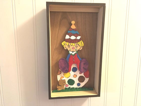 Wood shadow box of a shy clown