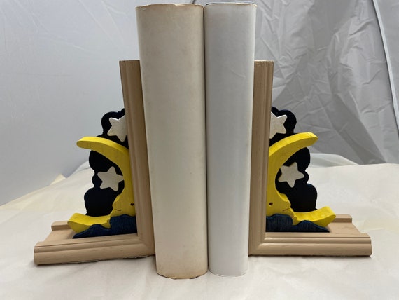Wooden bookend that shows a crescent moon