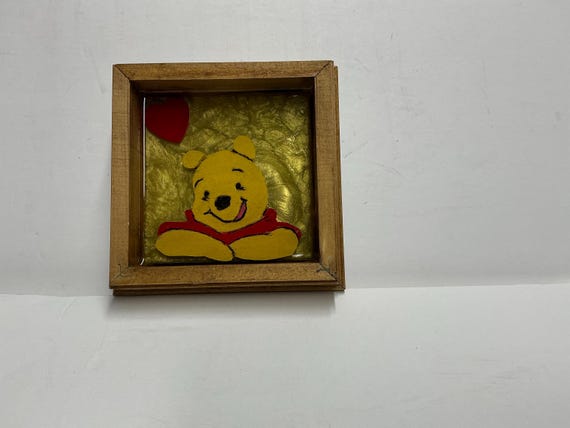 Small epoxied shadow boxes of Winnie the Pooh and friends