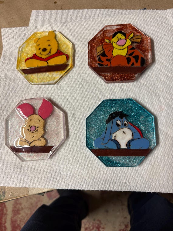 This is a set of 4 epoxied coasters that show Winnie the Pooh and 3 of his friends.