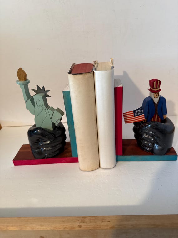 Wooden Bookend - Uncle Sam & Lady Liberty in the “hands of God”.