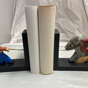 Wooden bookend of a miner and his mule