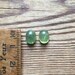Natural pale olive green sapphire oval cabochons matching pair 5.15ct