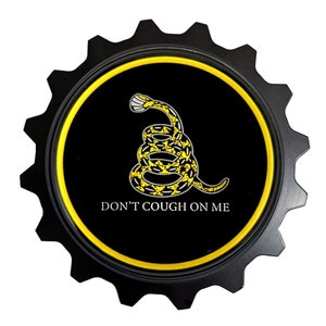 May include: A black and yellow gear-shaped sticker with a yellow snake coiled around a stick and the text "DON'T COUGH ON ME".