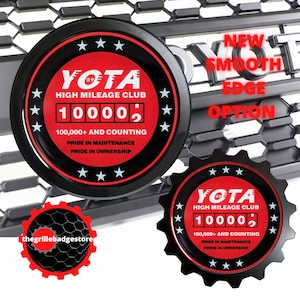 May include: Two black and red YOTA High Mileage Club emblems with a silver odometer reading 10000. The text on the emblems reads "100,000+ and counting", "Pride in Maintenance", and "Pride in Ownership".