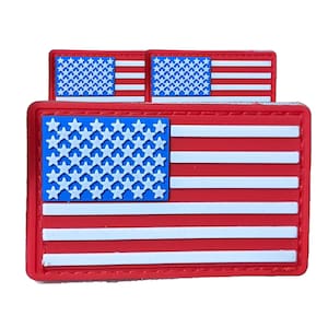 May include: Three red, white, and blue American flag patches. The top two patches are smaller and the bottom patch is larger. All three patches have a white border.