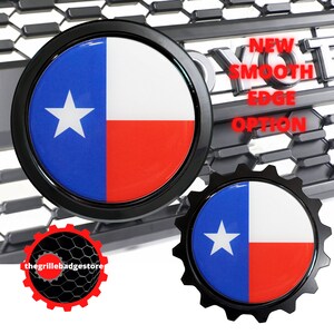 May include: Two black and white Texas flag emblems. The top emblem has a smooth edge and the bottom emblem has a gear-like edge. Both emblems have a white star on a blue background and a red stripe at the bottom.