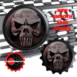 May include: Two black metal skull emblems with a red and white skull graphic. The skull has a distressed look. The text "NEW SMOOTH EDGE OPTION" is visible in the background.