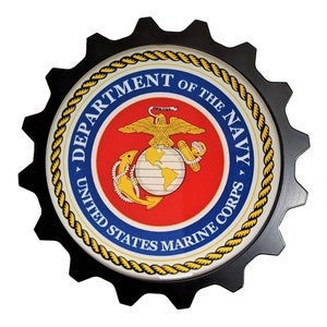 May include: A black and gold gear-shaped emblem with the words "Department of the Navy, United States Marine Corps" around a red, white, and blue emblem of the Marine Corps.